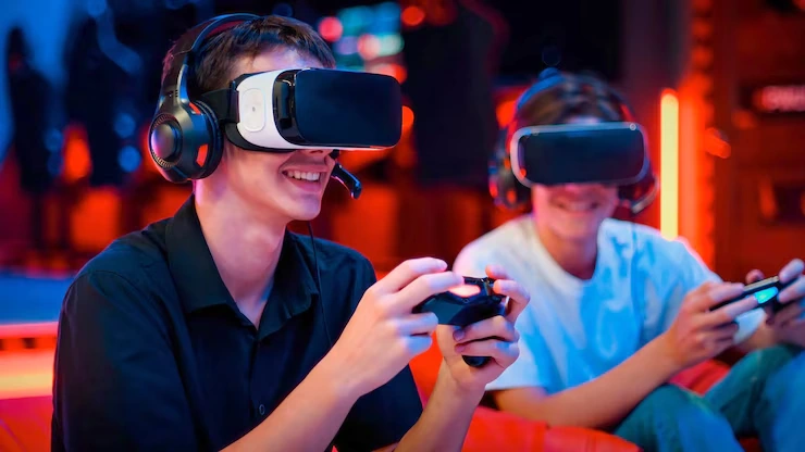 Teenagers using VR headsets playing a game made by a Roblox Game Development Agency in UK