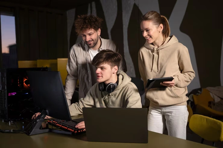 Multiplayer Game Development Agency in UK team collaborating on project at workstation