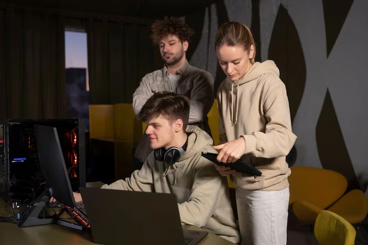 Cross Platform Game Development Agency in UK collaborating on game interface with multi-device setup